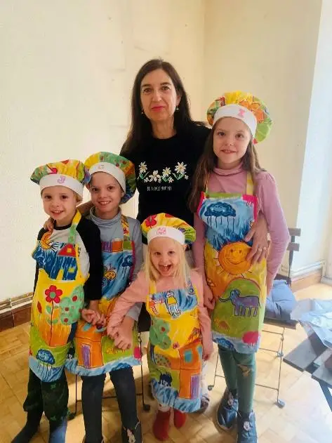 Carolina and her siblings wearing the chef’s hats and aprons made for them by cousin Maricarmen.
