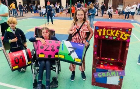 Fancy-dress contest at COAMI school: Carolina and her siblings with their cardboard bumper cars and the ticket booth.