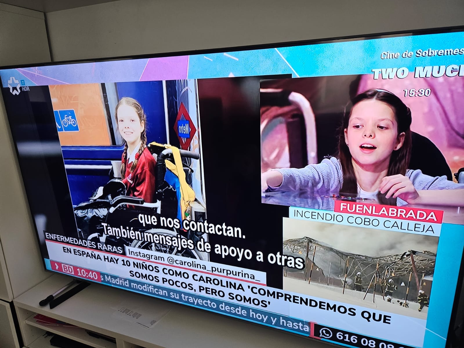 Television screen showing a news report on rare diseases: a girl in a wheelchair in the metro and another speaking to camera.