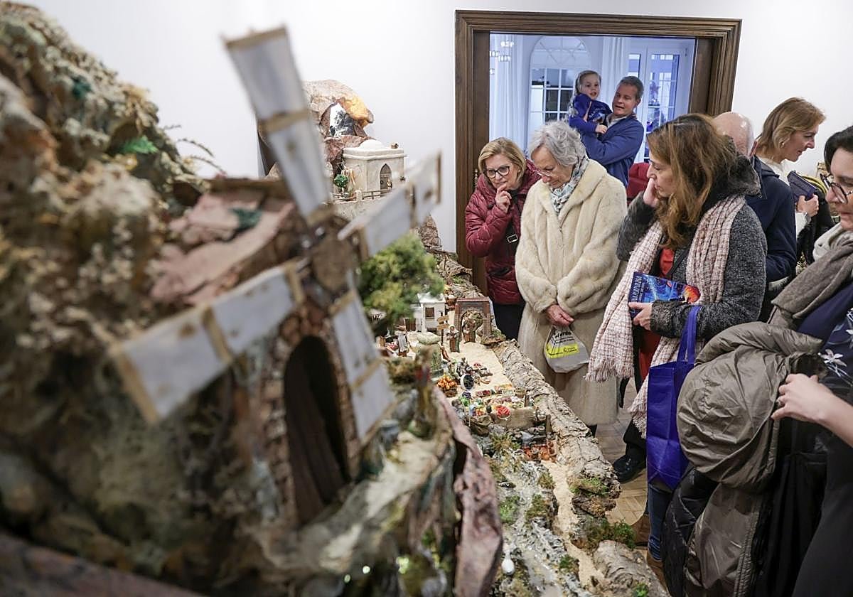 Visitors look at the family’s large nativity scene, with a windmill in the foreground, during the open day.