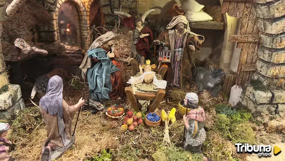 Figures of the charity nativity scene: Mary, Joseph holding a lantern, an angel and the Child in the manger, with a shepherd in the foreground.